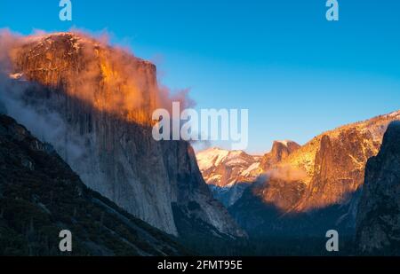 winter sunset shot of yosemite's el capitan and half dome as storm clouds clear from yosemite national park Stock Photo