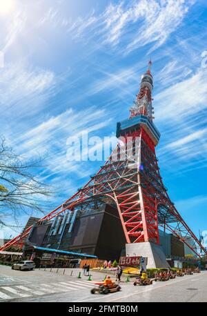 tokyo, japan - april 09 2019: Slope of Tokyo Tower street with a group of tourists wearing Mario Kart characters costumes and driving at foot of the t Stock Photo