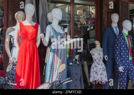 Colourful dresses and suits displayed on clothes shop mannequins in old town, Hoi An, Vietnam Stock Photo