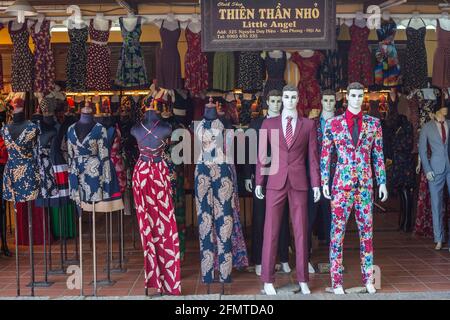 Snazzy designs on shop mannequins outside textile trader in Hoi An, Vietnam Stock Photo