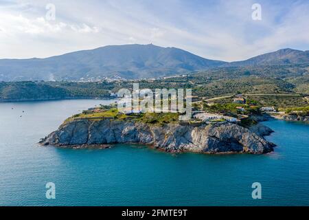 Port Lligat in Spain with a tree in the foreground. Port Lligat is a village located on the Costa Brava at northeastern Catalonia in Spain. Salvador D Stock Photo