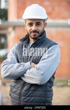 portrait of smiling young builder posing Stock Photo