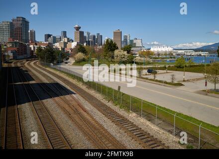 Rail Yard and Vancouver Skyline. Railroad tracks running near the waterfront in downtown Vancouver. Stock Photo