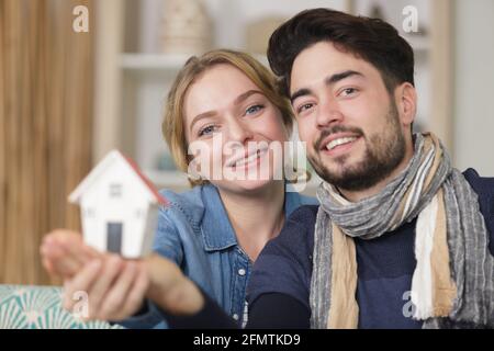 young couple showing affection with home symbol Stock Photo