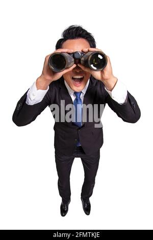 Surprised Young businessman  looking  through binoculars Stock Photo