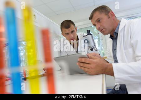 two scientists examining liquid in a test tube Stock Photo