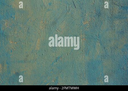 Blue painted over yellow background wall, textured surface Stock Photo