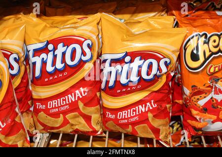 Fritos Original corn chips shot closeup at a grocery store that's bright and colorful on a metal shelf in a Kansas store. Stock Photo
