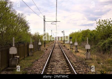 Rail crossing in an italian town on a cloudy day Stock Photo