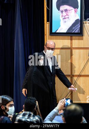 Tehran, Iran. 11th May, 2021. Former Iranian Defense Minister Hossein Dehghan (R) leaves after he registered his candidacy for the 13th presidential race at the Interior Ministry in Tehran, Iran, on May 11, 2021. Iran's Ministry of Interior Affairs on Tuesday officially started registering candidates for the 13th presidential race, state TV reported. Credit: Ahmad Halabisaz/Xinhua/Alamy Live News Stock Photo