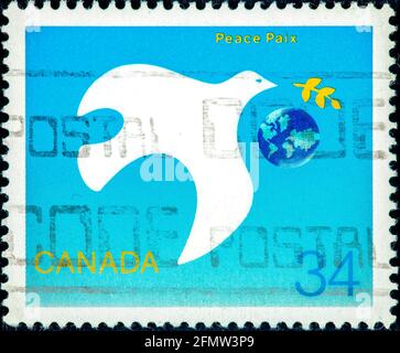 Canada - CIRCA 1986: Postage stamp printed in Canada shows Peace dove with branch, International Peace Year serie, circa 1986 Stock Photo
