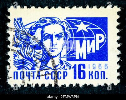 CCCP - CIRCA 1966: A stamp printed in the CCCP shows a woman and a pigeon, circa 1966 Stock Photo