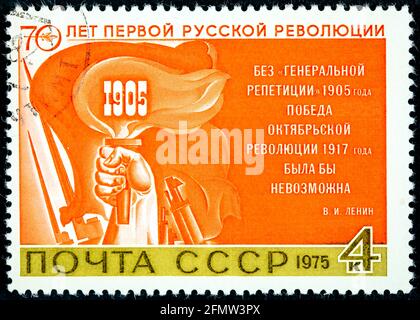 USSR - CIRCA 1975: Postage stamp Hand with torch printed in USSR. Series: 70th anniversary of the first Russian revolution of 1905 by artists V. Yakun Stock Photo