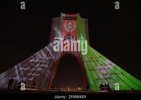 Tehran, Iran. 11th May, 2021. To memorial the victims of the terrorist attack in Dasht-e Barchi, Afghanistan flag video mapping was performed on the walls of Azadi Tower in Tehran, the capital city of Iran. (Photo by Sobhan Farajvan/Pacific Press) Credit: Pacific Press Media Production Corp./Alamy Live News Stock Photo