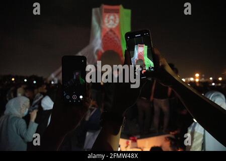 Tehran, Iran. 11th May, 2021. To memorial the victims of the terrorist attack in Dasht-e Barchi, Afghanistan flag video mapping was performed on the walls of Azadi Tower in Tehran, the capital city of Iran. (Photo by Sobhan Farajvan/Pacific Press) Credit: Pacific Press Media Production Corp./Alamy Live News Stock Photo