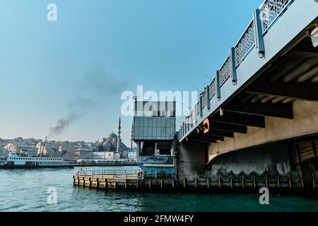 Old galata bridge bottom and many fishing rod and hook with old ottoman mosque background in istanbul bosporus during morning and sunny day Stock Photo