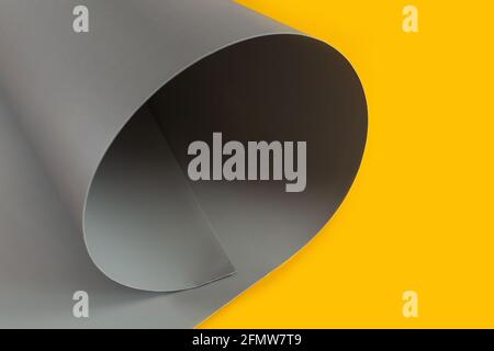 Grey and yellow craft cardboard folded in curls. Close up of geometric abstract shape. Glitch effect. Stock Photo