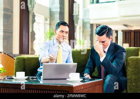 Asian Businessman thinking while having a meeting Stock Photo