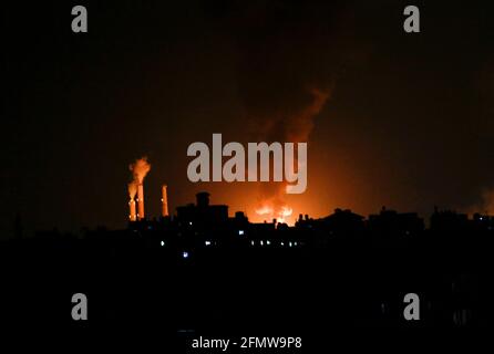 Gaza, Palestine. 11th May, 2021. A huge column of smoke seen from Gaza city billows from an oil facility in the southern Israeli city of Ashkelon, on May 11, 2021, after rockets were fired by the Palestinian Hamas movement from the Gaza Strip towards Israel. (Photo by Mahmoud Issa/SOPA Images/Sipa USA) Credit: Sipa USA/Alamy Live News Stock Photo