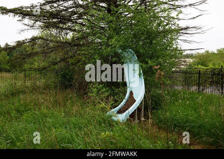 A pool water slide that is completely overgrown. Stock Photo