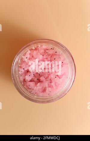 Body scrub of sea salt with lemon, rosemary and olive oil in glass jar on stone table, homemade cosmetic for Spa care Stock Photo