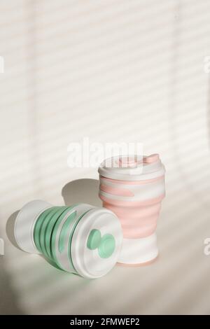 Stylish reusable eco coffee cup on white background. Ban single use plastic. Zero waste concept. Sustainable lifestyle Stock Photo