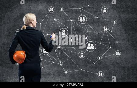 Businesswoman designing social network interaction Stock Photo
