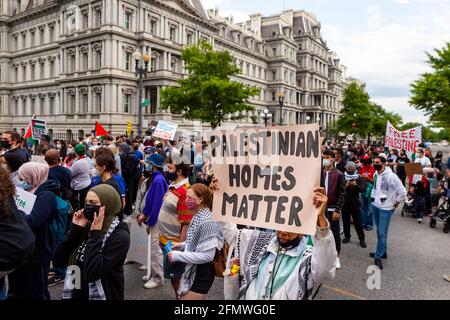 Washington, DC, USA, 11 May, 2021.  Pictured: A staunch supporter of many social justice issues in the DC area holds a 'Palestinian Homes Matter' sign during a march calling for the United States to stop funding apartheid, occupation, and violence in Palestine.  Credit: Allison C Bailey / Alamy Live News Stock Photo