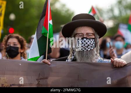 Washington, DC, USA, 11 May, 2021.  Pictured: A Jewish man who is against the occupation of Palestine carries the banner at the front of a protest calling for the United States to stop funding apartheid, occupation, and violence in Palestine.  Credit: Allison C Bailey / Alamy Live News Stock Photo