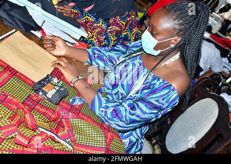 African seamstress sews clothes. Workplace of tailor Stock Photo