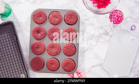 Flat lay. Step by step. Cooling red velvet cupcakes on a kitchen drying rack. Stock Photo