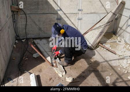 A man dismantling his old garage. Stock Photo