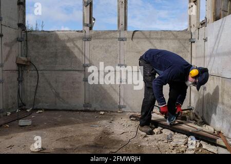 A man dismantling his old garage. Stock Photo