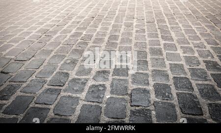 The Granite cobblestoned pavement background. Selective focus Stock Photo