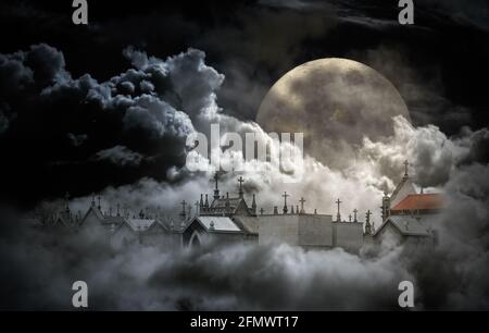 Mysterious old cemeteryin the middle of clouds in a full moon night Stock Photo