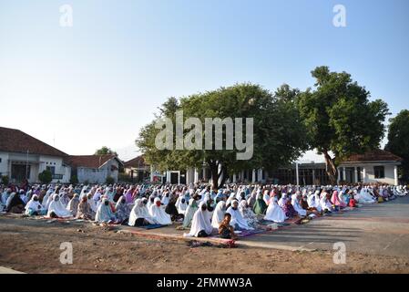 Majalengka, West Java, Indonesia - July 31, 2020 : Indonesian Muslims in suburban attend Eid Al-Adha prayers in a yard at a local mosque Stock Photo