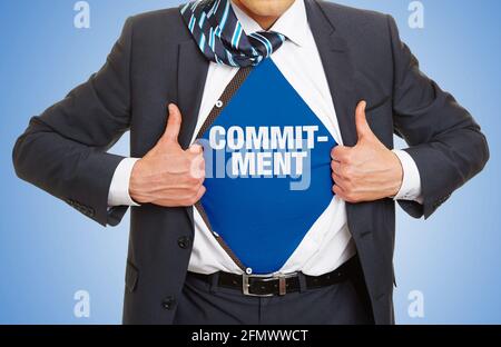 Man in suit shows lettering Commitment as a commitment concept Stock Photo