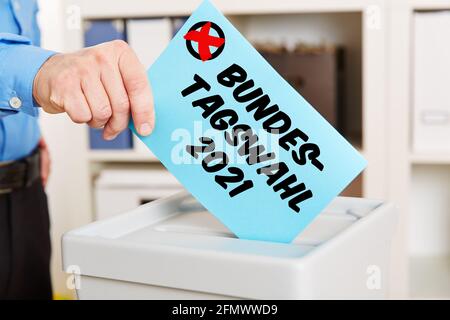 Hand when voting for the Bundestagswahl (German for: Federal Parliament election) in 2021 at a ballot box Stock Photo