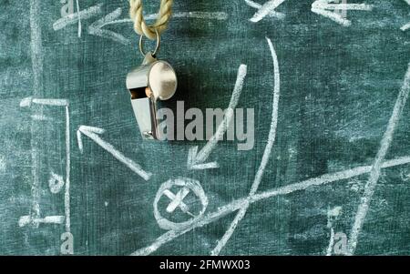 whistle of a soccer coach or referee and soccer tactics diagram on blackboard, great soccer event this year