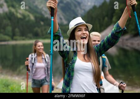 Group of fit healthy friends trekking in the mountains Stock Photo