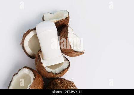 Deodorant and coconut on white background with copy space Stock Photo