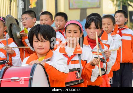 A primary school marching band welcoming guests to the school in rural Shandong, China. Stock Photo