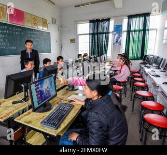 Students from Weiqiao Central Primary School in Xiuning, Anhui, China using computers during class. Stock Photo