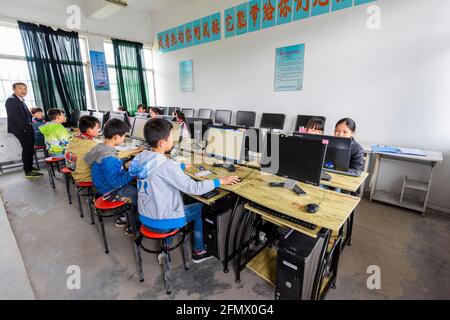 Students from Weiqiao Central Primary School in Xiuning, Anhui, China using computers during class. Stock Photo