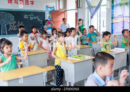 Students from Weiqiao Central Primary School in Xiuning, Anhui, China learning American Sign Language. Stock Photo