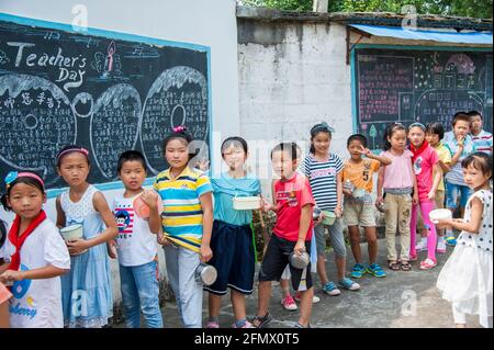 Student lining up for lunch and returning lunch plates in a rural school in Xiuning, Anhui, China Stock Photo