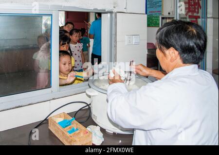 Student lining up for lunch and returning lunch plates in a rural school in Xiuning, Anhui, China Stock Photo