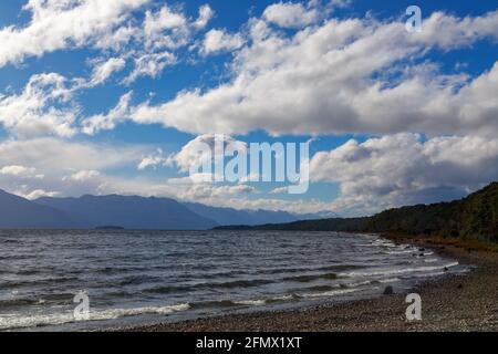 A sky full of fluffy clouds above Lake Te Anau, the biggest lake in the South Island of New Zealand Stock Photo