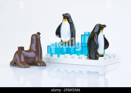 KHARKIV, UKRAINE - March 29th, 2020: Toy seal and penguins, plastic toys, pre-school education theme, isolated on white Stock Photo