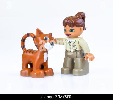 KHARKIV, UKRAINE - March 29th, 2020: Toy girl pets  toy cat, plastic toys, pre-school education theme, isolated on white Stock Photo